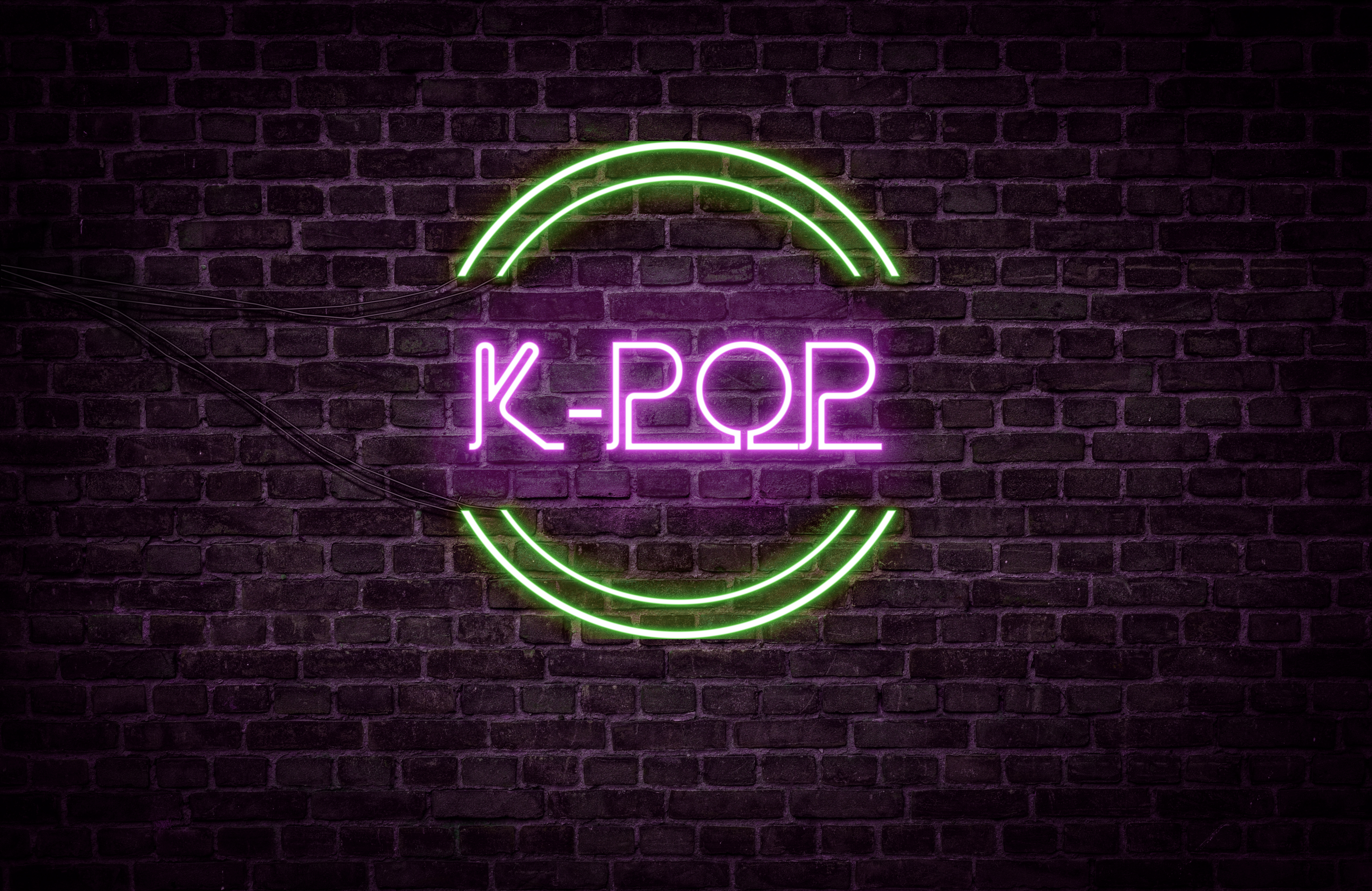 A green and purple neon light sign that reads: K-POP - Relative Insight